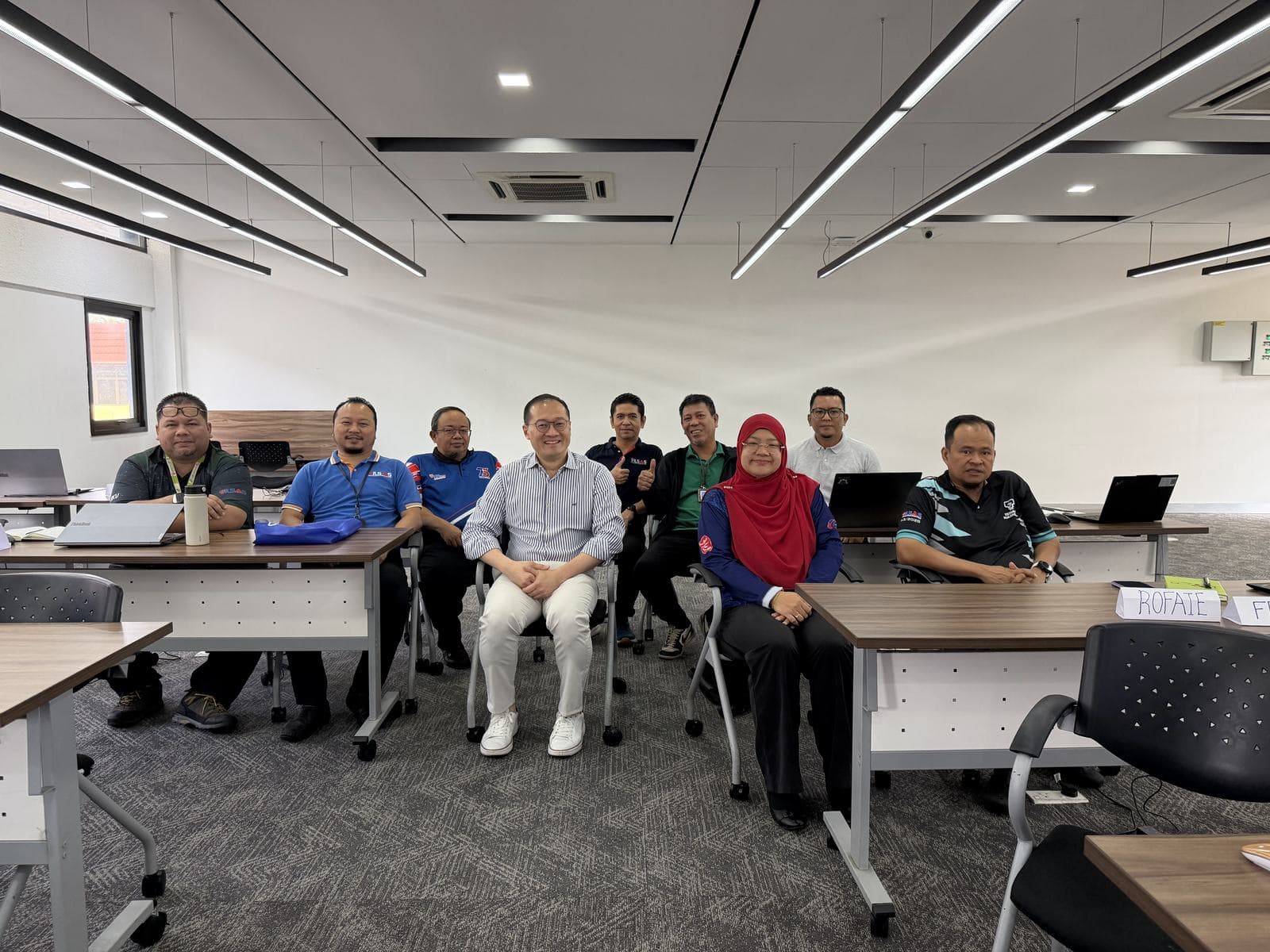 Group photo of participants seated together in a classroom after a workshop session