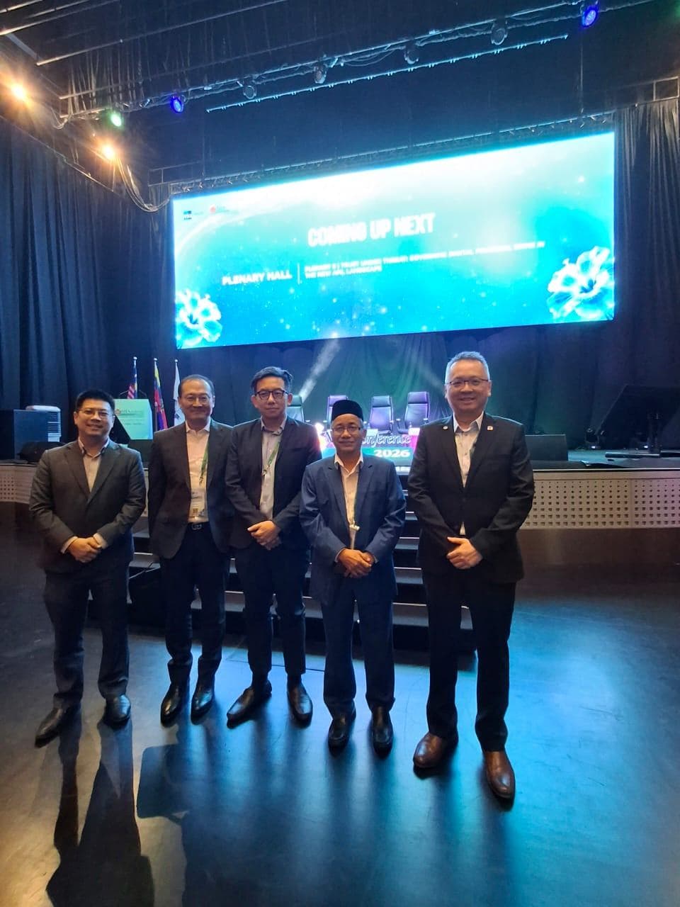 Panellists standing together on stage in suits at the MIA International Accountants Conference 2026, before the AI in Finance session